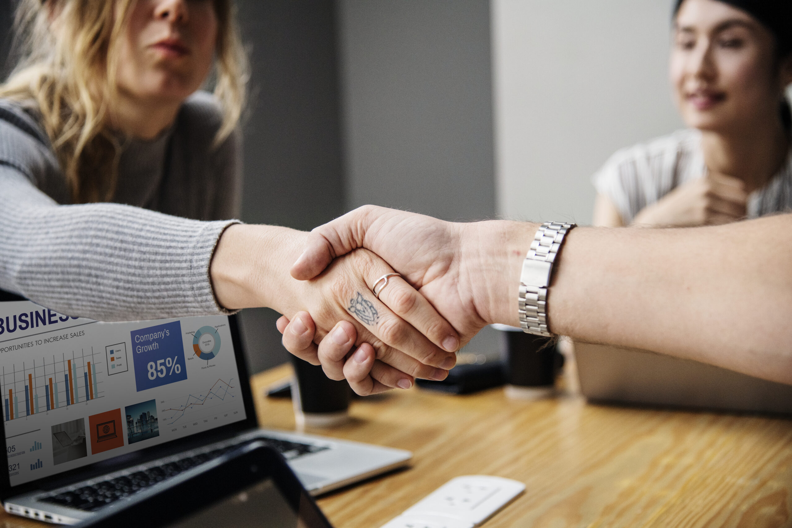 Business people shaking hands in agreement Social Shopping